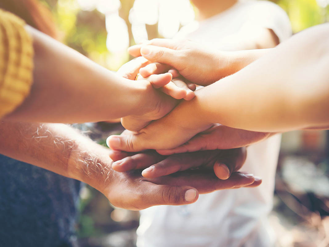 Close up of young people putting their hands together. Team with Close up of young people putting their hands together. Team with